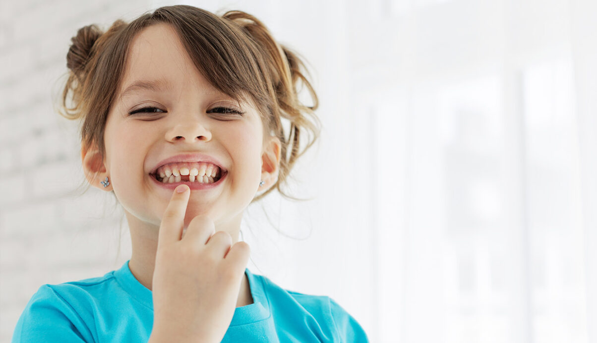 image of a child holding down lip to expose tooth gap