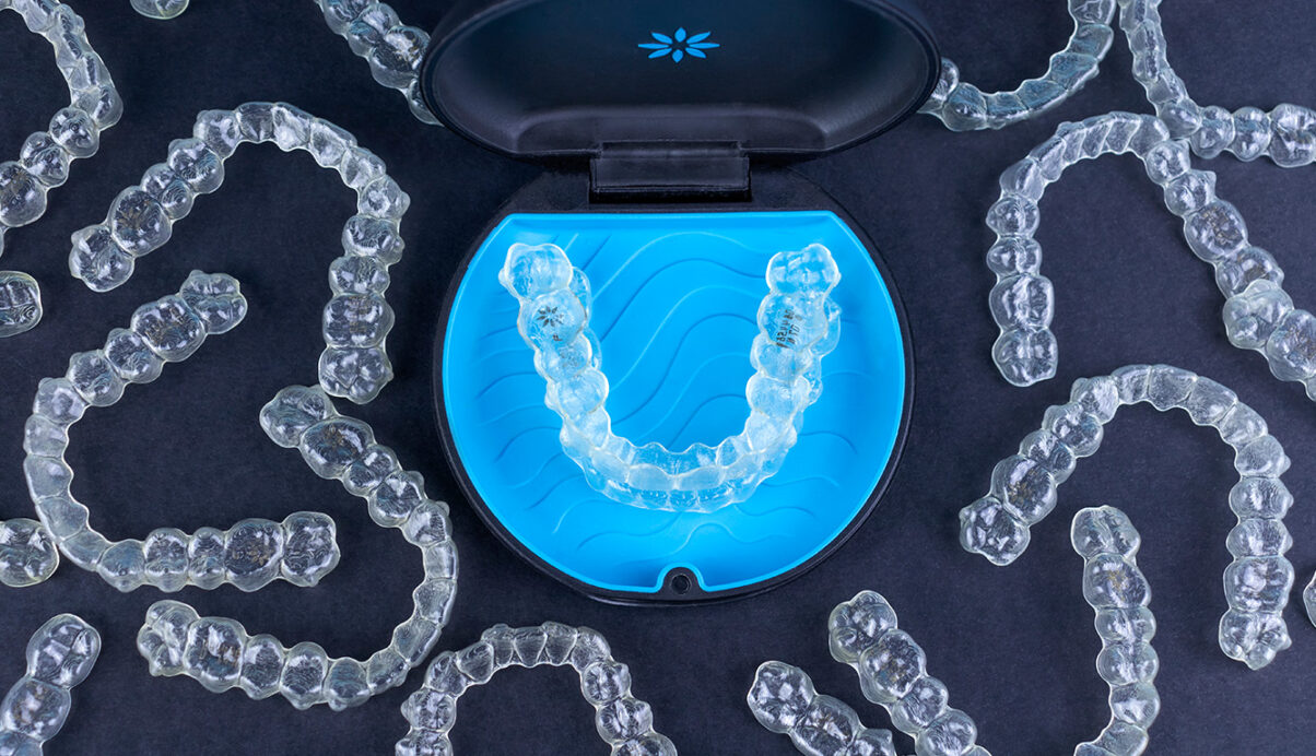 invisalign aligner in case surrounded by clear aligners