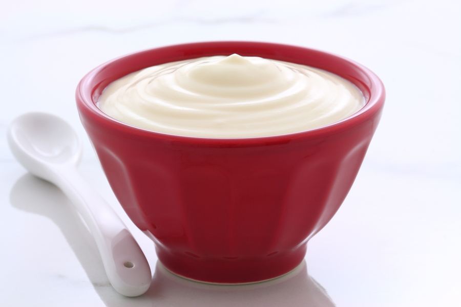 Delicious nutritious and healthy fresh plain yogurt on vintage french cafe au lait bowl.