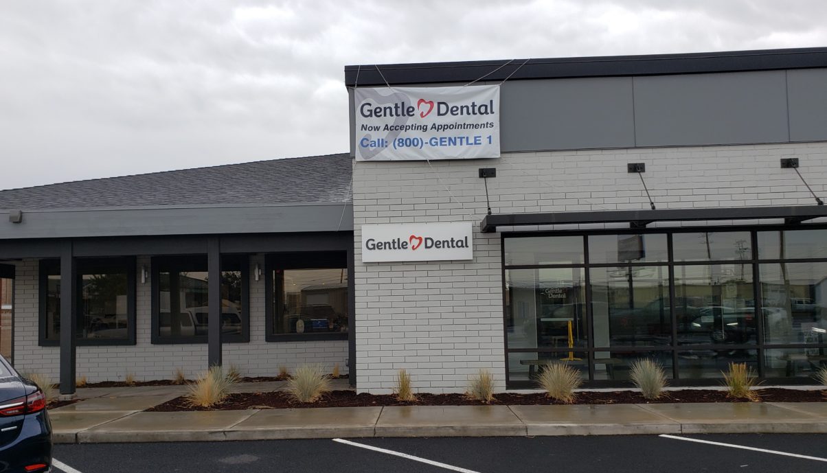 Gentle Dental office front in Redmond, Oregon with a "now accepting appointments" banner